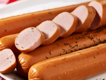 Sausages cut sliced into pieces with spice close up big portionの写真素材