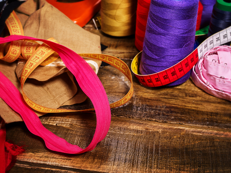 Sewing accessories coil threads and measuring tape in basket supplies close up. Every season range is always updated. Choice of sewing accessories depends on type of product.の写真素材
