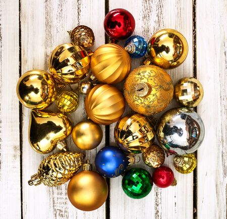 Christmas wreath of Xmas balls decorations hangs on front door who made from white wooden boards on square frame.の写真素材