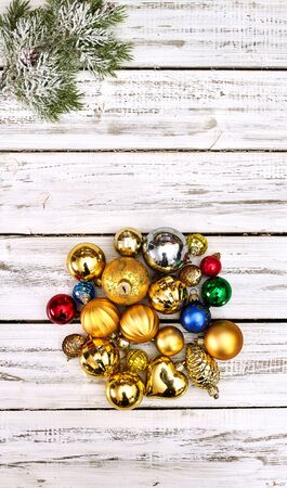 Christmas wreath of Xmas balls decorations hangs on front door who made from white wooden boards.の写真素材