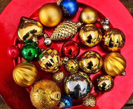 Christmas decorations design top view of Xmas balls ornaments on close up red plate.の写真素材