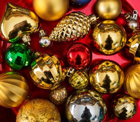 Christmas decorations design top view of Xmas balls ornaments on red plate. Square frame close up.の写真素材
