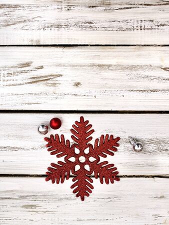 Christmas snowflake decoration and Xmas glitter ball white wooden boards. Vertical long frame and copy space.の写真素材