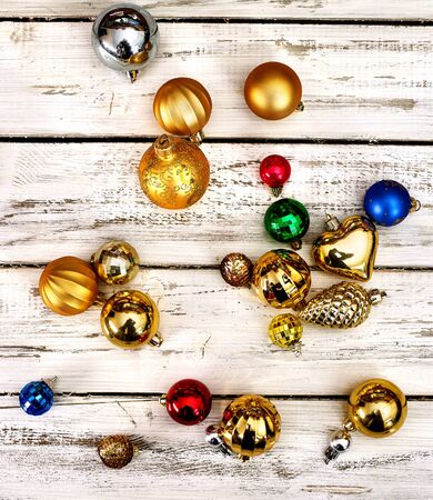 Christmas decorations scattered design top view of Xmas balls ornaments on white wooden table. Square frame .の写真素材