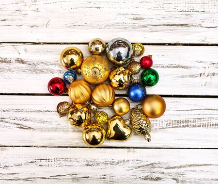 Christmas stack of Xmas balls decorations on white wooden boards on square frame with copy space around still life .の写真素材