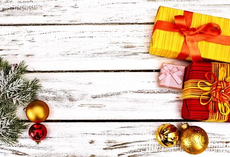 Christmas decorations scattered design of Xmas balls ornaments and gift box on white wooden table. Top view horizontal long frame .の写真素材