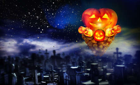 Halloween pumpkin in graveyard. Concept of jack-o-lantern pumkin tornado up over cemetery night on star sky background.の写真素材
