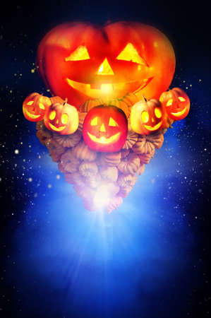 Halloween pumpkin in dark night sky. Concept of jack-o-lantern pumkin tornado up in bright star burst background.の写真素材