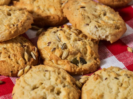 Oatmeal cookies is on gingham checkered fabric on table in rustic style. Healthy food breakfast.の写真素材