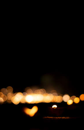 diwali Hindu festival of lights. Clay lamp candle illuminated. Traditional oil lamp on dark bokeh background, copy space.の写真素材