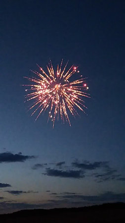 Fireworks in the night sky with stars and clouds in the backgroundの写真素材