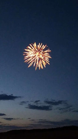 fireworks in the night sky, with stars and clouds in the backgroundの写真素材