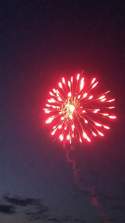 Fireworks in the night sky. Red and white fireworks in the night sky.の写真素材