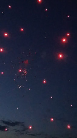 Fireworks in the night sky with stars and clouds in the backgroundの写真素材