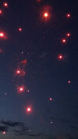 Fireworks in the night sky with stars in the night sky.の写真素材