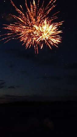 fireworks in the night sky with a lot of sparks and smokeの写真素材
