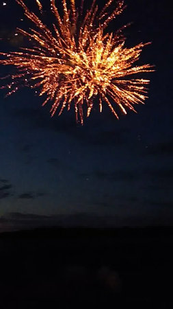 Beautiful fireworks in the night sky over the sea. Selective focus.の写真素材