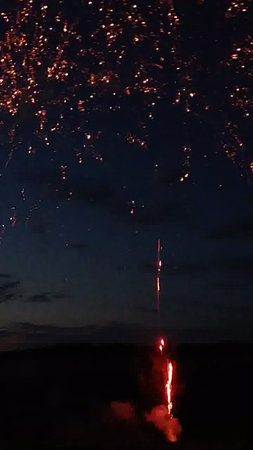 Fireworks in the night sky with a lot of smoke and fireの写真素材