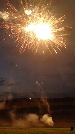 fireworks in the night sky with smoke and fire on the backgroundの写真素材