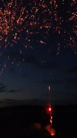 fireworks in the night sky with clouds and stars in the backgroundの写真素材