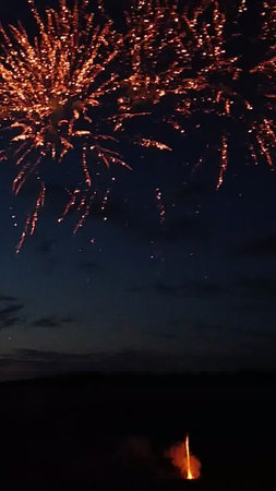 Fireworks in the night sky with a lot of smoke and fireの写真素材