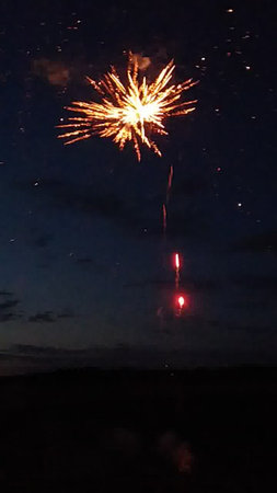Fireworks in the night sky with stars and space for text.の写真素材