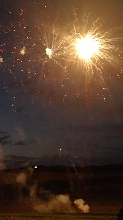 fireworks in the night sky with a lot of smoke and fireの写真素材