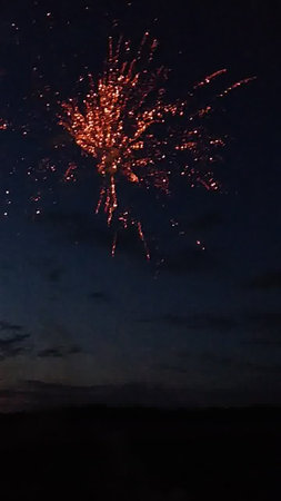 fireworks in the night sky with clouds and stars on the backgroundの写真素材