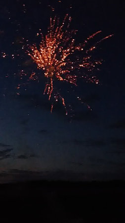 fireworks in the night sky with reflection in water, holiday backgroundの写真素材