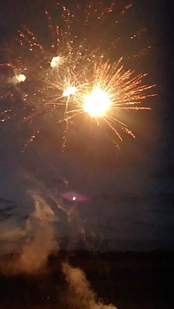 fireworks in the night sky, with smoke and firecrackersの写真素材