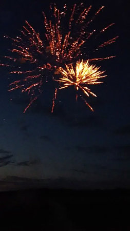 Fireworks in the night sky with the silhouette of the mountains.の写真素材