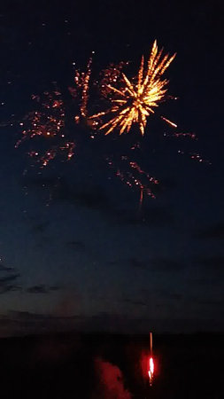 Fireworks in the night sky, with a lot of sparklesの写真素材