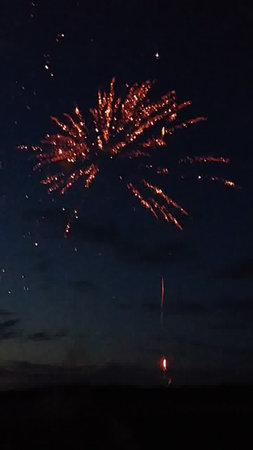 Fireworks in the night sky with a lot of smoke and fireの写真素材