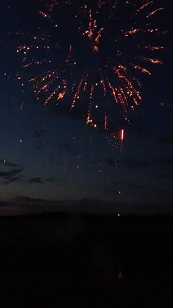 fireworks in the night sky with stars and clouds in the backgroundの写真素材