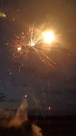 Fireworks in the night sky with smoke and firecrackers.の写真素材