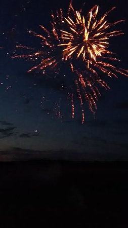 fireworks in the night sky with clouds and stars in the backgroundの写真素材