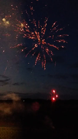 Colorful fireworks in the night sky over the village. Independence Day celebration.の写真素材