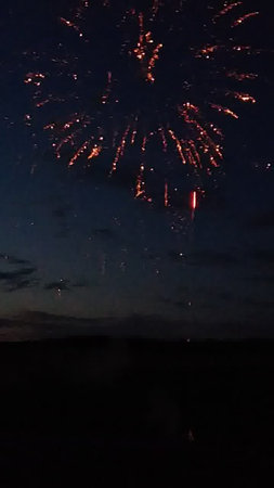 Colorful fireworks in the night sky over the sea. Beautiful holiday backgroundの写真素材