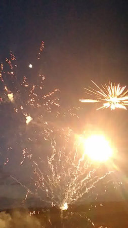 fireworks in the night sky with a lot of smoke and sparksの写真素材