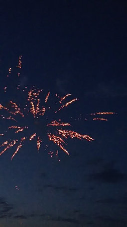 fireworks in the night sky with stars and clouds in the skyの写真素材