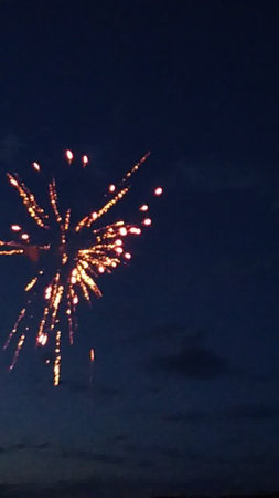 fireworks in the night sky with clouds and stars in the skyの写真素材