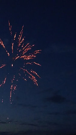 fireworks in the night sky with stars and clouds in the backgroundの写真素材