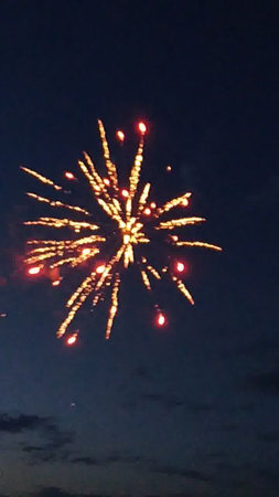 fireworks in the night sky with a lot of light on itの写真素材