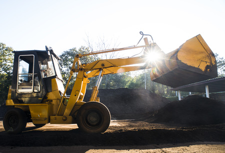 Front loader working with organic compost productionの写真素材