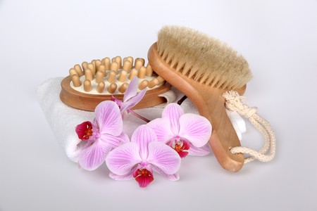 Pink stripy phalaenopsis orchid with a white towel and brushの写真素材