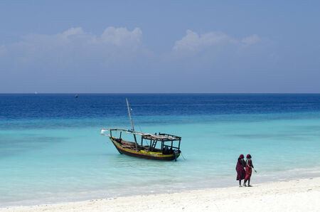 Zanzibar Nungwi Beach, Tanzania, Africa 15 December 2013   Group of male Masai on a beautiful Zanzibar beach in traditional clothes  Amaizing colors - light sand blue sky and turquoise ocean のeditorial素材
