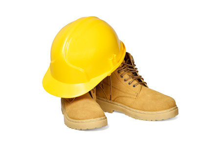 Protection helmet and boots isolated over white with clipping path の写真素材