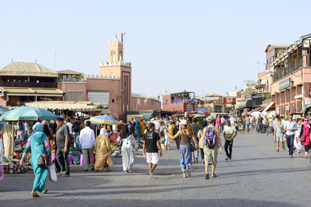 Tourists visiting Djemaa el Fna - market place in Marrakesh medina quarter on 24 August 2014 in Marrakesh, Morocco. Djemaa el Fna is a UNESCO world heritage site.のeditorial素材