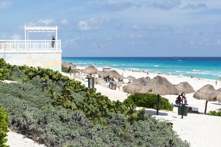 Tourists enjoy the sunny weather and relaxing on the Playa Delfines on 22 January 2015 in Cancun, Mexico. This is one of the best beaches in the Mexico.のeditorial素材