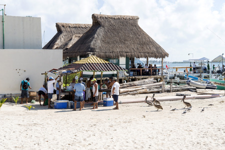 Fishermen sell fresh fish on the beach on 21 January 2015 in Isla Mujeres, Mexico. The island is...